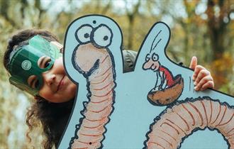 Image of child with a picture of Superworm