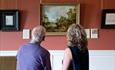 A couple looking at a painting