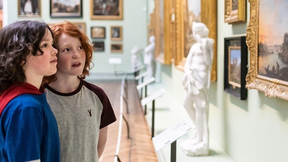 Two children looking at paintings at the Bowes Museum