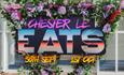 Text reads, 'Chester le Eats' and is surrounded by a border of pink and purple flowers.