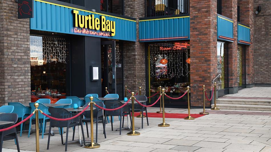 The front exterior of Turtle Bay with outdoor seating