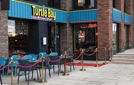 The front exterior of Turtle Bay with outdoor seating