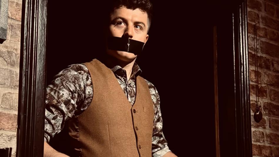 Tom Bolton with tape over his mouth. Tom Bolton with tape over his mouth.