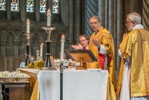 Three members of the Church blessing three Holy Oils at Durham Cathedral.