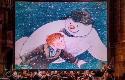 Image of 'The Snowman' being screened in front of a live orchestra.