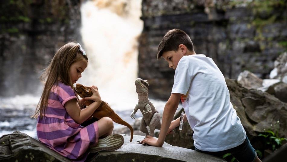 Dinosaur Discovery Trail at High Force. Children playing with dinosaurs by High Force Waterfall.