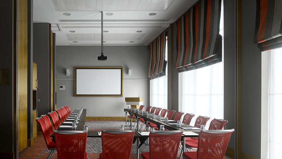 Meeting room with chairs, large table and screen