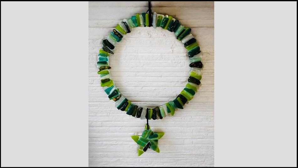 A wreath make from fused glass, various colours of green. A wreath make from fused glass, various colours of green.