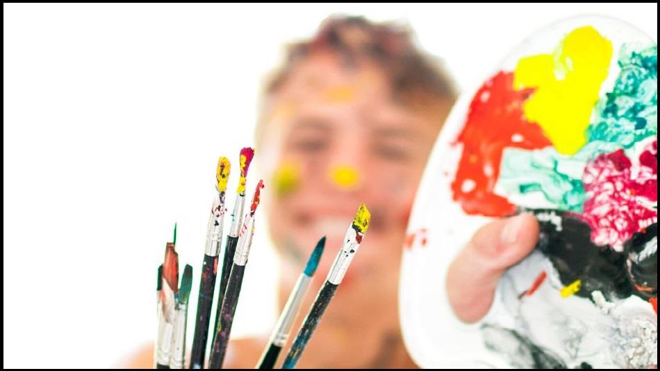 Image of a young person holding paintbrushes and a palette.