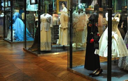 Image of a display of antiquated dresses.