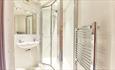shower room with sink and heated towel rail