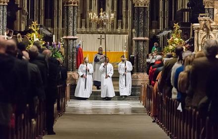 Carol service at Durham Cathedral with congregation and members of the clergy.