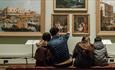 family of four sat admiring artwork inside The Bowes Museum