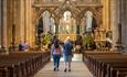 couple walking through the nave inside Durham Cathedral