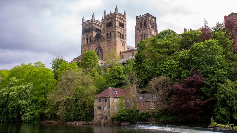view of the west and central towers of Durham Cathedral with trees, Fulling Mill and River Wear in the foreground