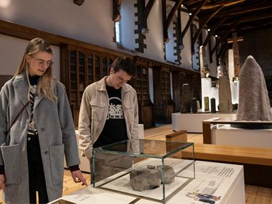 A couple looking at exhibitions inside Durham Cathedral Museum