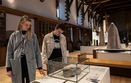 A couple looking at exhibitions inside Durham Cathedral Museum