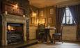 Image of the cosy pub at South Causey Inn - a corner table next to a roaring fire.