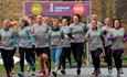 group of runners wearing matching t shirts running in the Durham City Run.