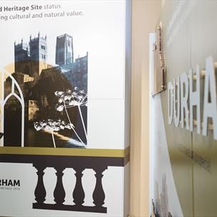 Image of an information board showing Durham Cathedral and text describing the World Heritage Site at Palace Green Library.