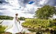 A bride in front of a lake
