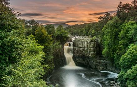 View of High Force Waterfall during sunset