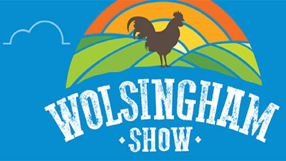 Image showing the words 'Wolsingham Show' and a silhouette of a rooster depicted against rolling hills at sunrise.