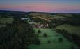 View of Lord Crewe Arms, Blanchland village and surrounding Durham Dales countryside from above during sunrise.
