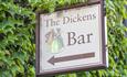 A sign saying The Dickens Bar