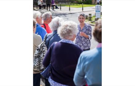 Jan Williams engaging a tour on Palace Green Durham