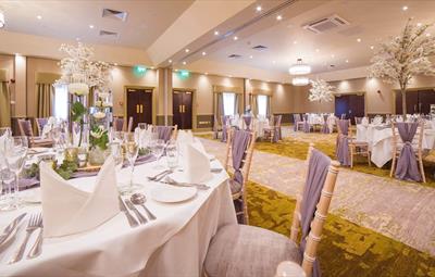 Image of a room in Redworth Hall Hotel which has been beautifully set for a wedding.