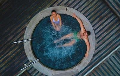Overhead shot of woman and man in hot tub.