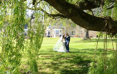 Image of a bride and groom in the grounds of Hall Garth Hotel Darlington.