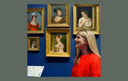 Image of a woman looking at paintings in The Bowes Museum