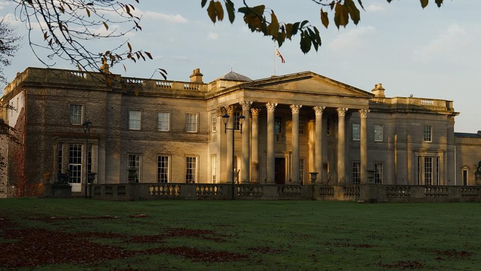 Exterior view of Wynyard Hall in Autumn with leaves on grass