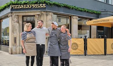 Four members of staff standing outside of the Pizza Express restaurant