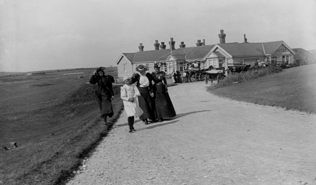 Group of four Victorian women and girls in front of Beachy Head Hotel