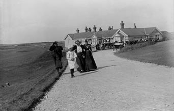 Group of four Victorian women and girls in front of Beachy Head Hotel