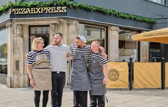 Four members of staff standing outside of the Pizza Express restaurant