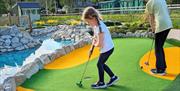 Children playing Miniature Golf