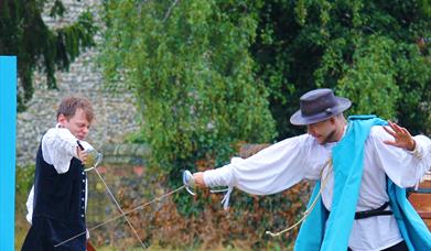 Two men take part in a sword-fight