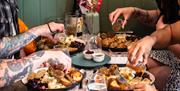 A group of four people eating a vegan roast dinner