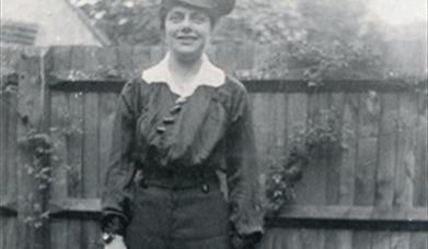 Edwardian woman in military style uniform in her garden in Eastbourne