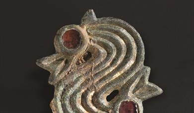 gold Dragon head brooch found with one of Eastbourne's Saxon Ancestors. Red garnets to mark the eyes.
