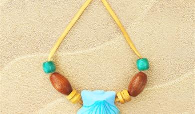 Mermaid necklace made from wooden and glass beads with a clam shell at the centre