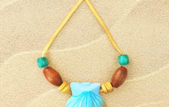 Mermaid necklace made from wooden and glass beads with a clam shell at the centre
