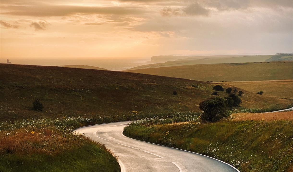 Wet road after the rain heading towards Birling Gap at sunset