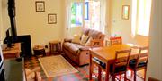 The Cosy living-room with recliner sofa and log burner at Carpenter's Cottage, in East Yorkshire
