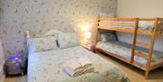 A bedroom with double bed and a single bed at Rialto Holiday Apartments in East Yorkshire.