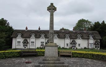 Warter village, East Yorkshire with  Memorial Cross and thatched cottages